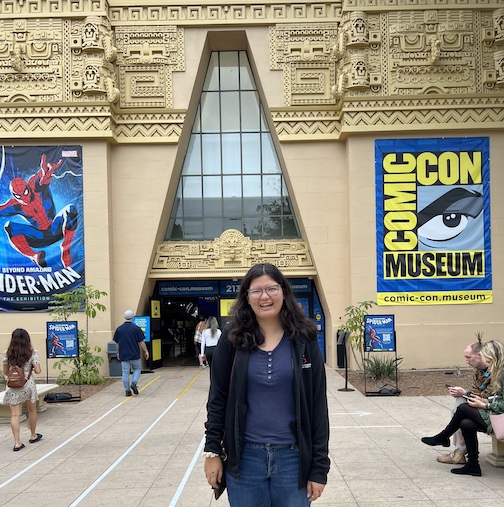 Grace deVega standing in front of the entrance to the Comic-Con Museum.